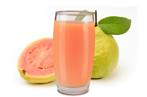 organic guava juice in glass cup isolated on white background with fresh guavas